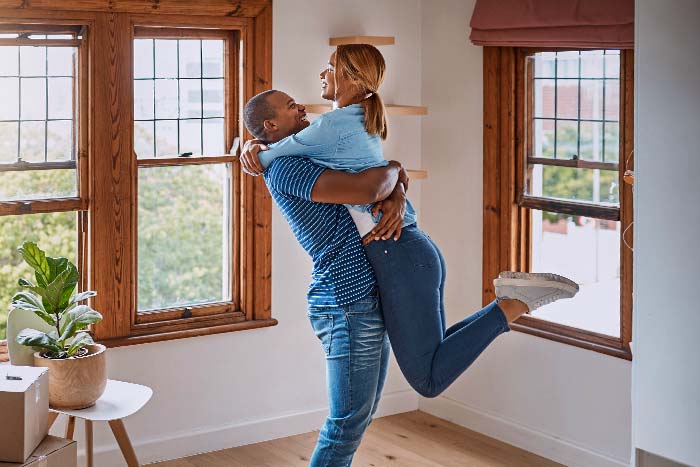 Loving young couple celebrating their new home