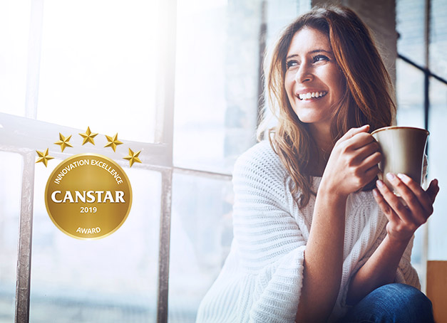Girl looking into the window and holding to a cup.