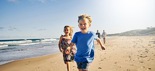 Happy kids running on the beach