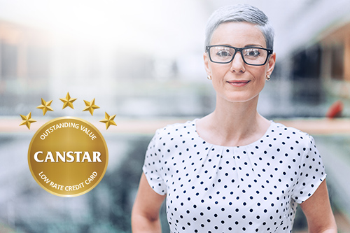 Lady wearing glasses and Canstar award.